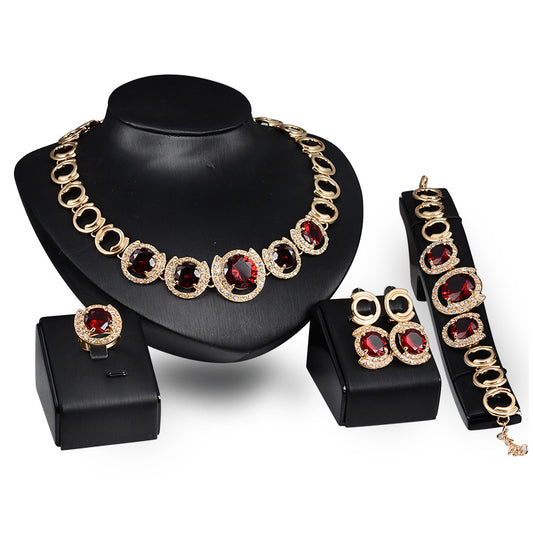 Vera™ Bridal Set — gold-toned bridal jewellery set on a mannequin display, red gemstone colourway
